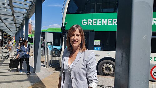 Jane Dodds MS in front of a bus